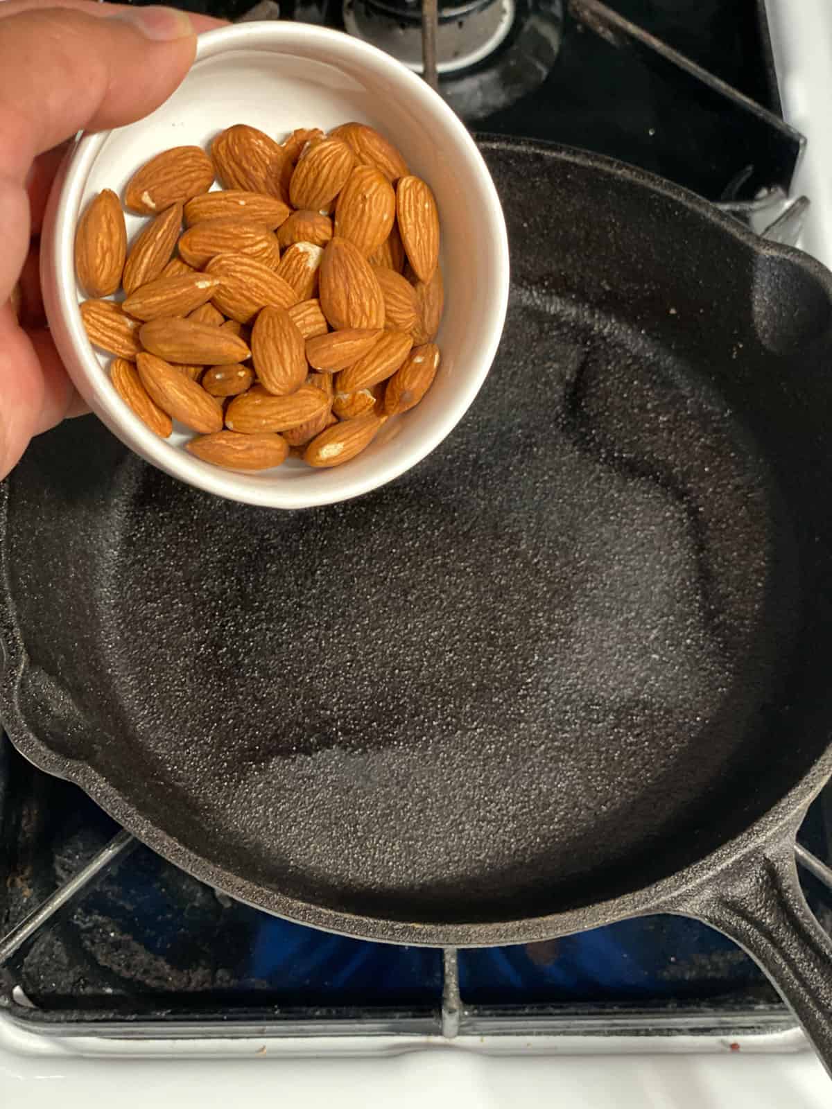 process shot of adding almonds to pan
