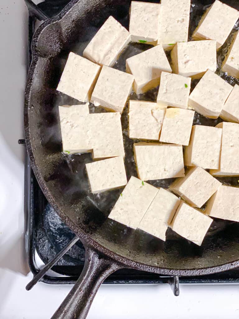process shot of tofu being cooked on pan