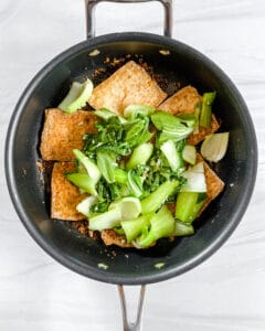 process of adding veggies to Spicy and Sweet Tofu in skillet
