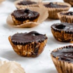 Completed No-Bake Peanut Butter Cups on a white surface.