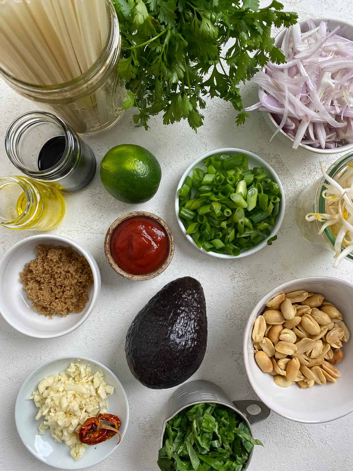ingredients for Vegan Vegetable Pad Thai measured out against a white surface