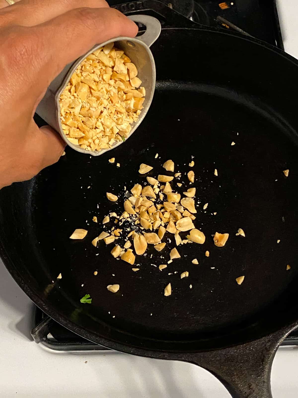 process of adding peanuts to pan