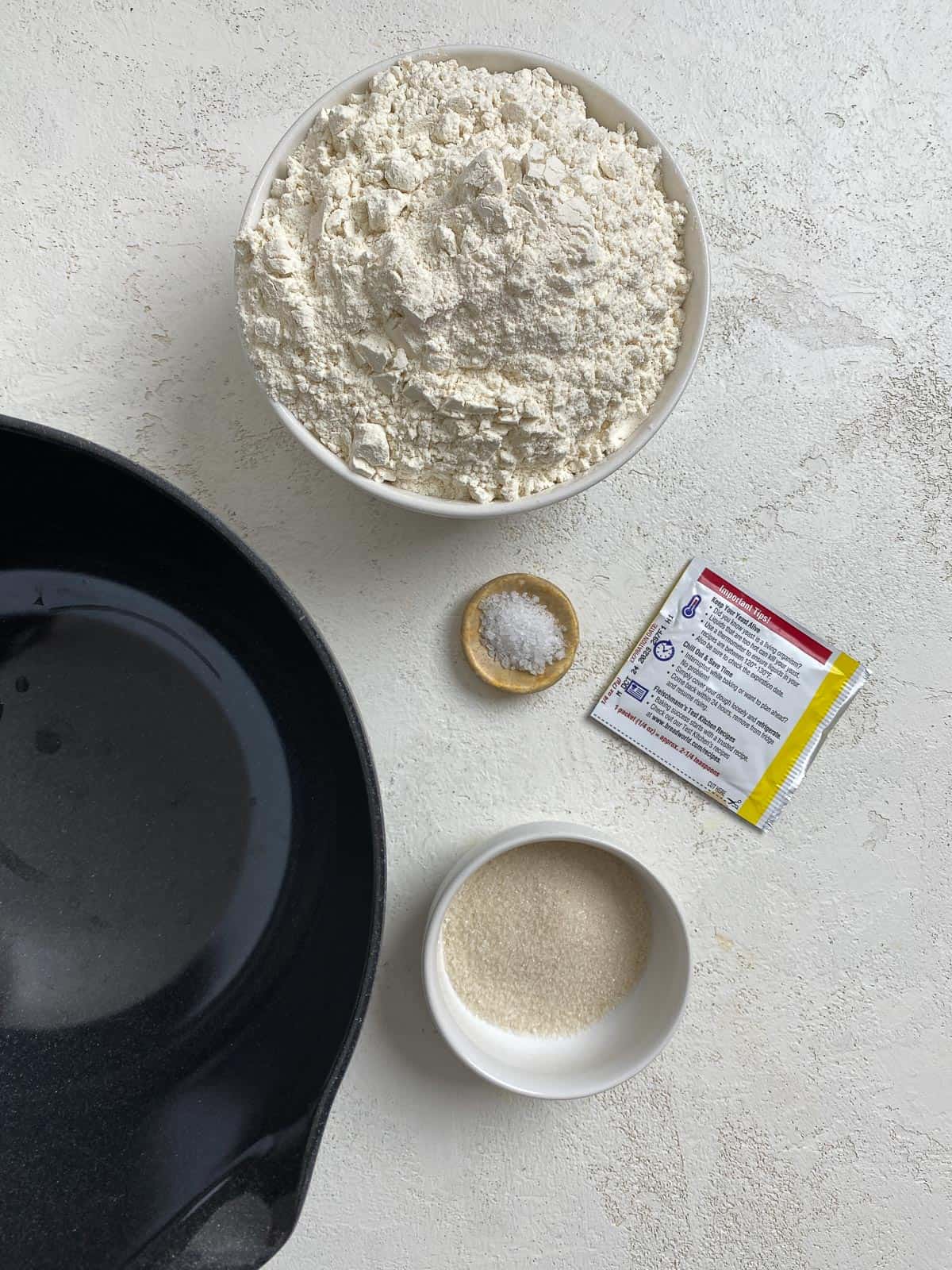 ingredients for These Homemade Vegan Cinnamon Rolls spread out on a white surface