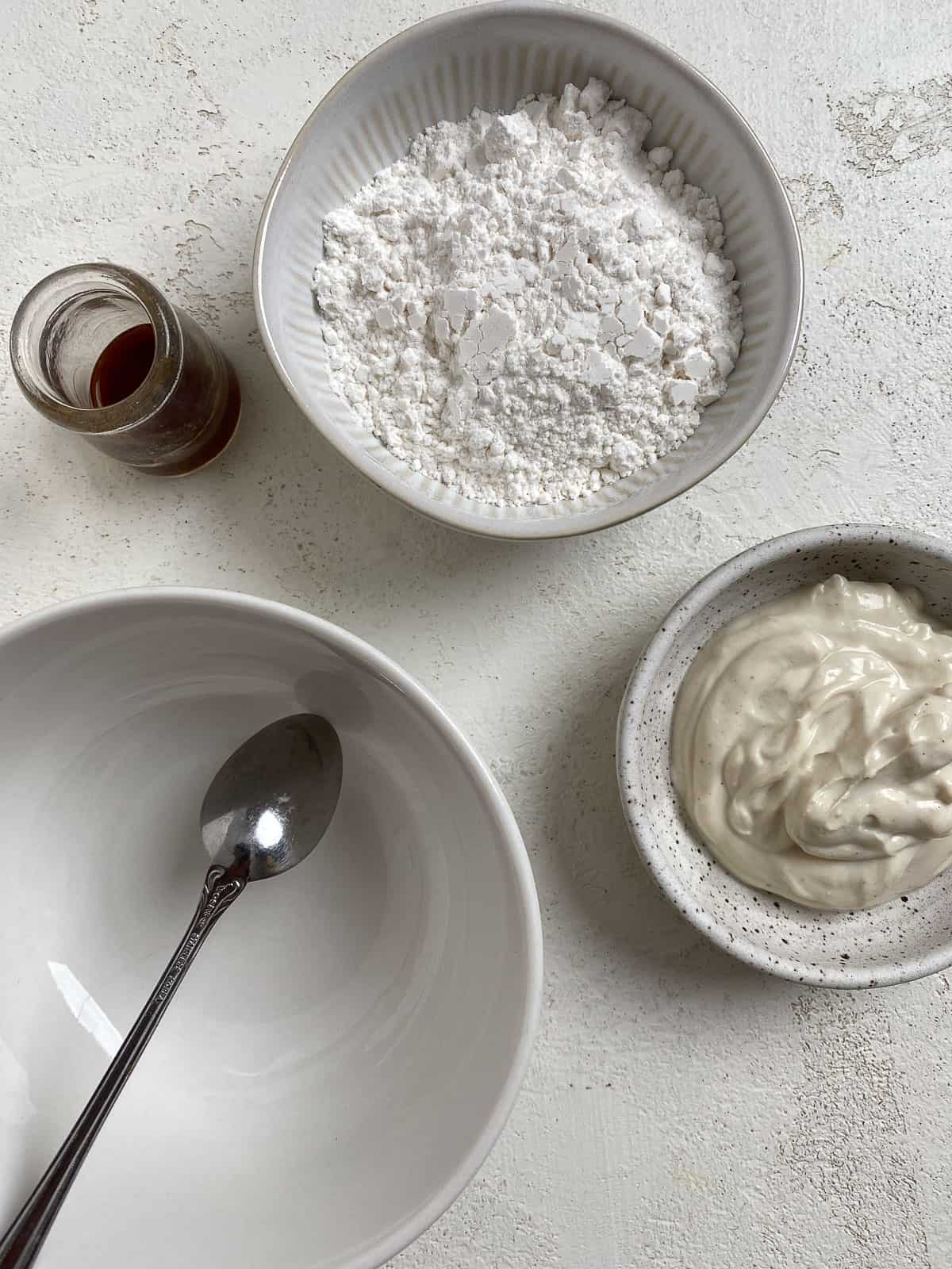 ingredients for cinnamon dough glaze against a white surface