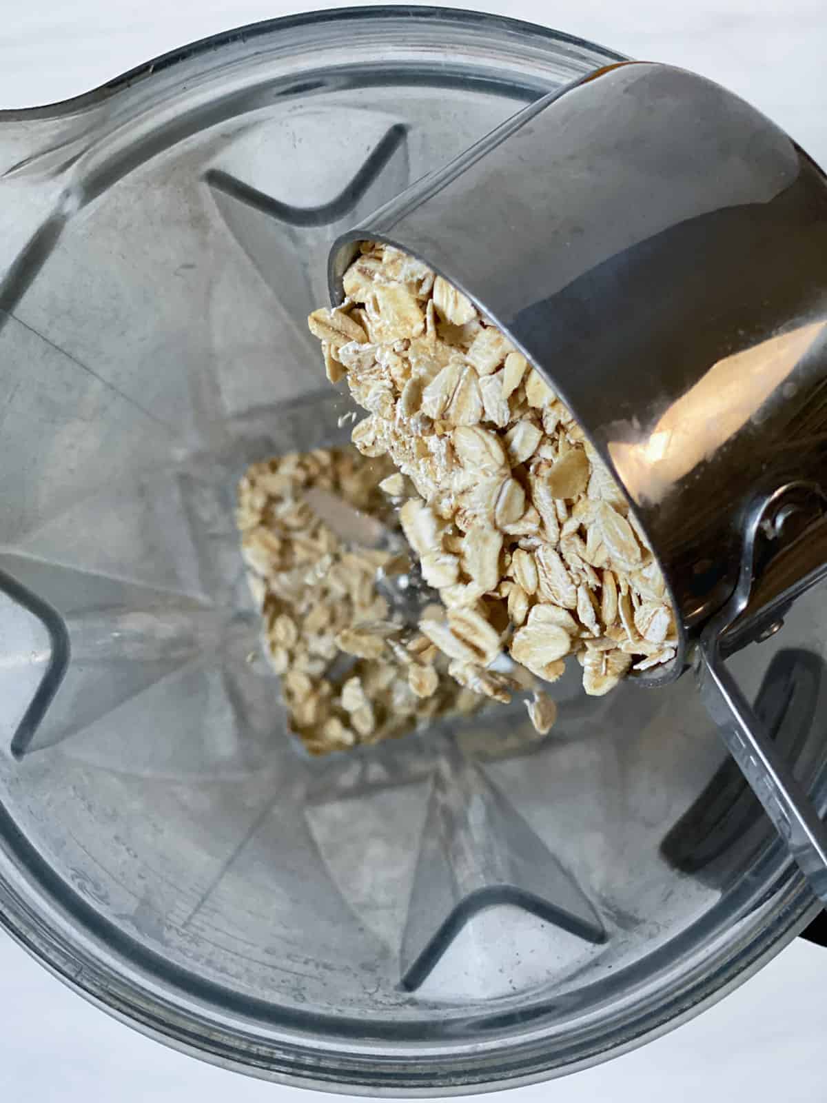 process of adding oatmeal to food processor