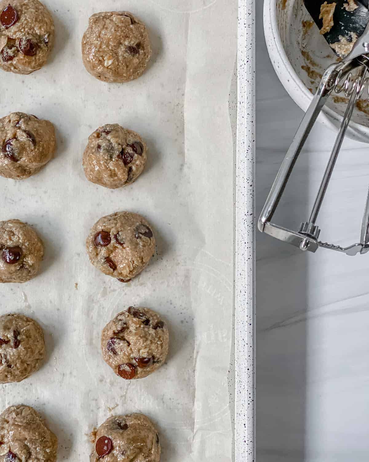 process of adding Chocolate Chip Banana Bites dough onto parchment paper