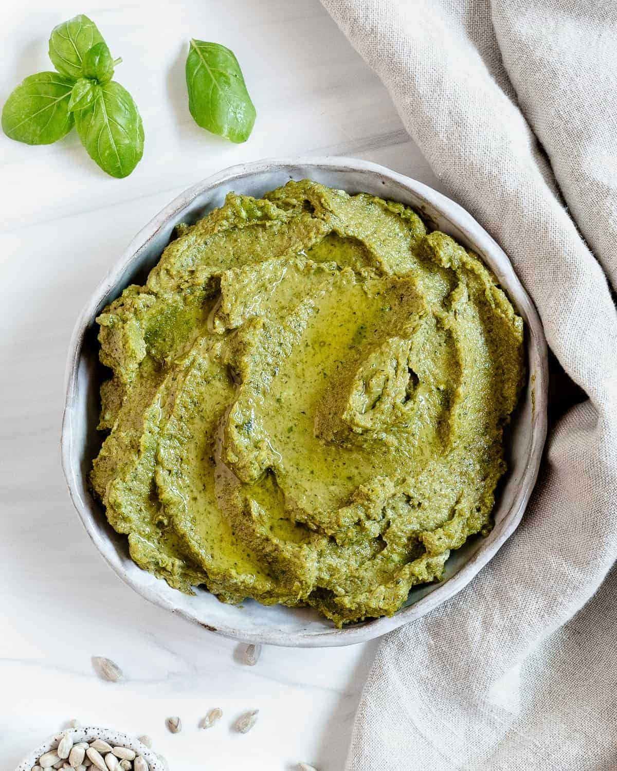 completed Sunflower Seed Pesto in a white bowl against a white background