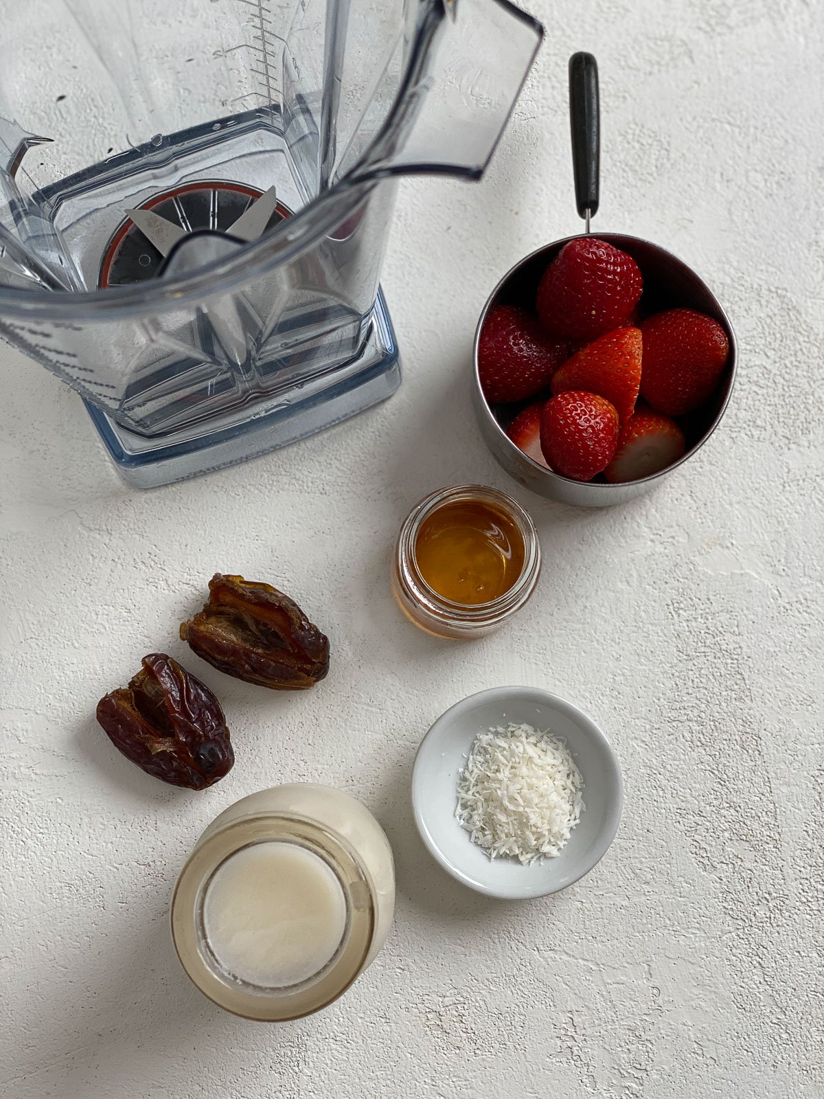 ingredients for Vegan Strawberry Overnight Oats against a white surface