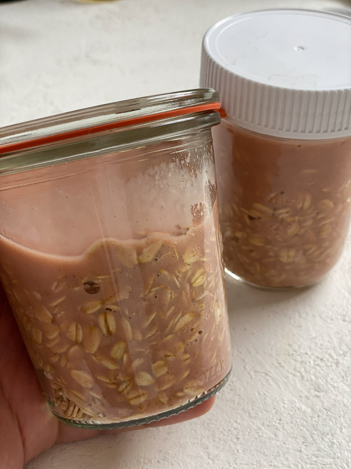 two glass jars of oats plus mixture prior to being refrigerated