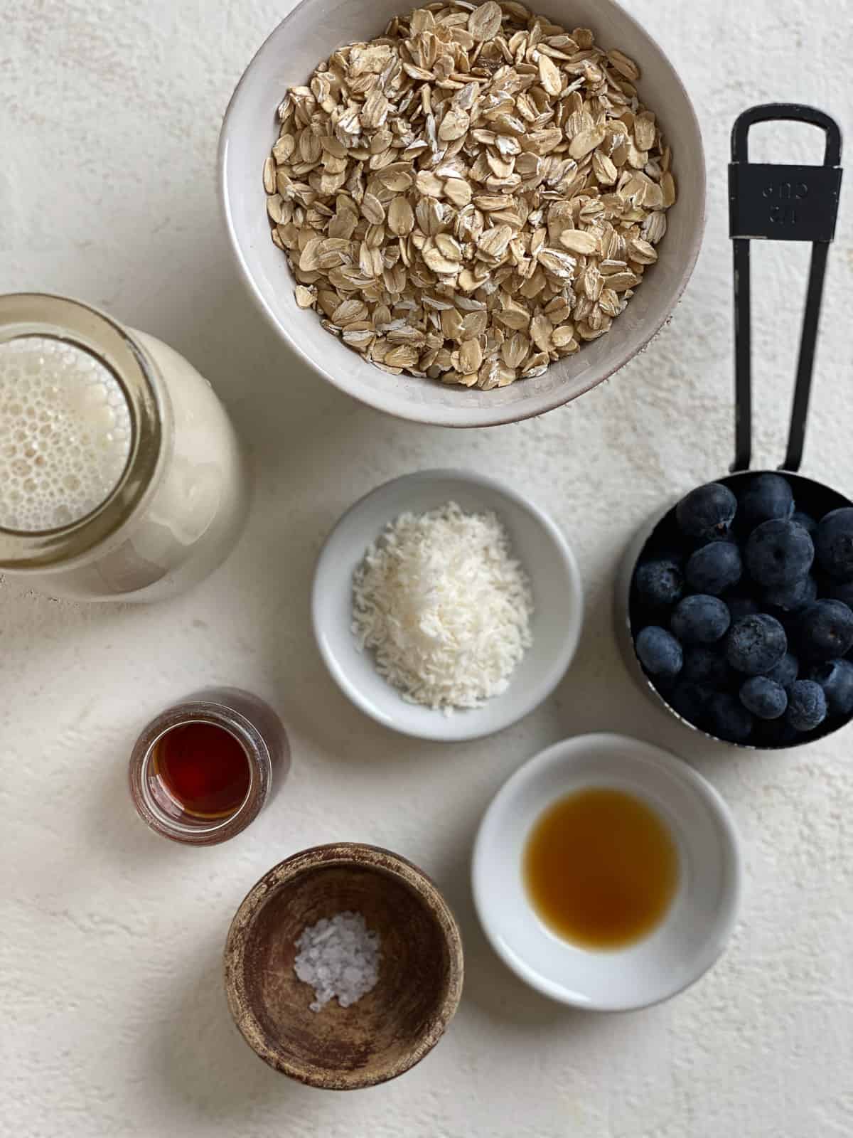 ingredients for Blueberry Overnight Oats scattered against a white surface