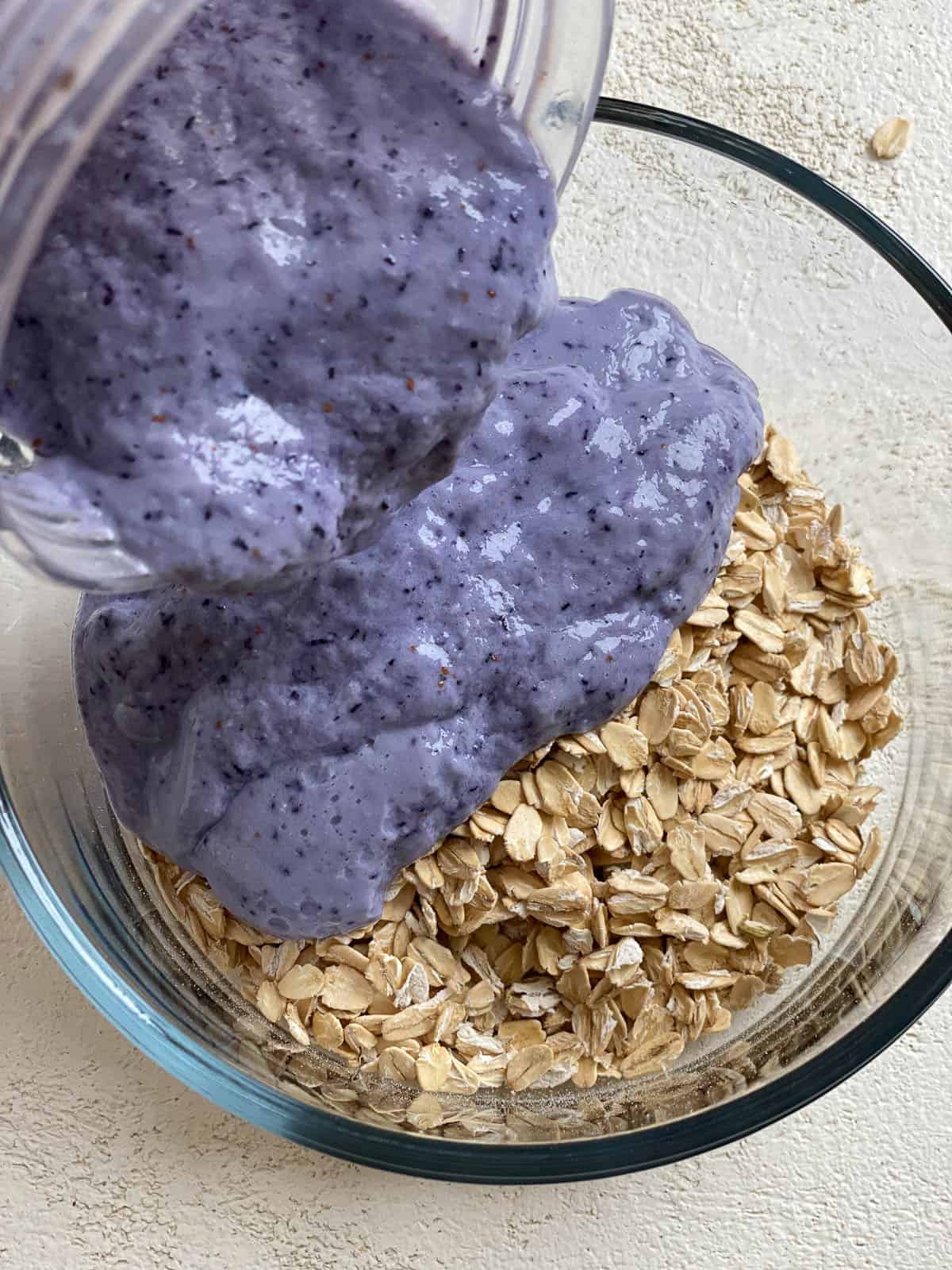 process shot of adding blueberry mixture to oats