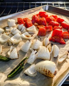 process of roasting vegetables in a baking tray
