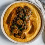 completed creamy mushroom polenta in a white bowl