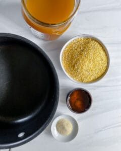 ingredients for creamy mushroom polenta around a pan