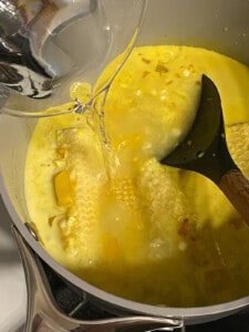 process shot of adding water to pan