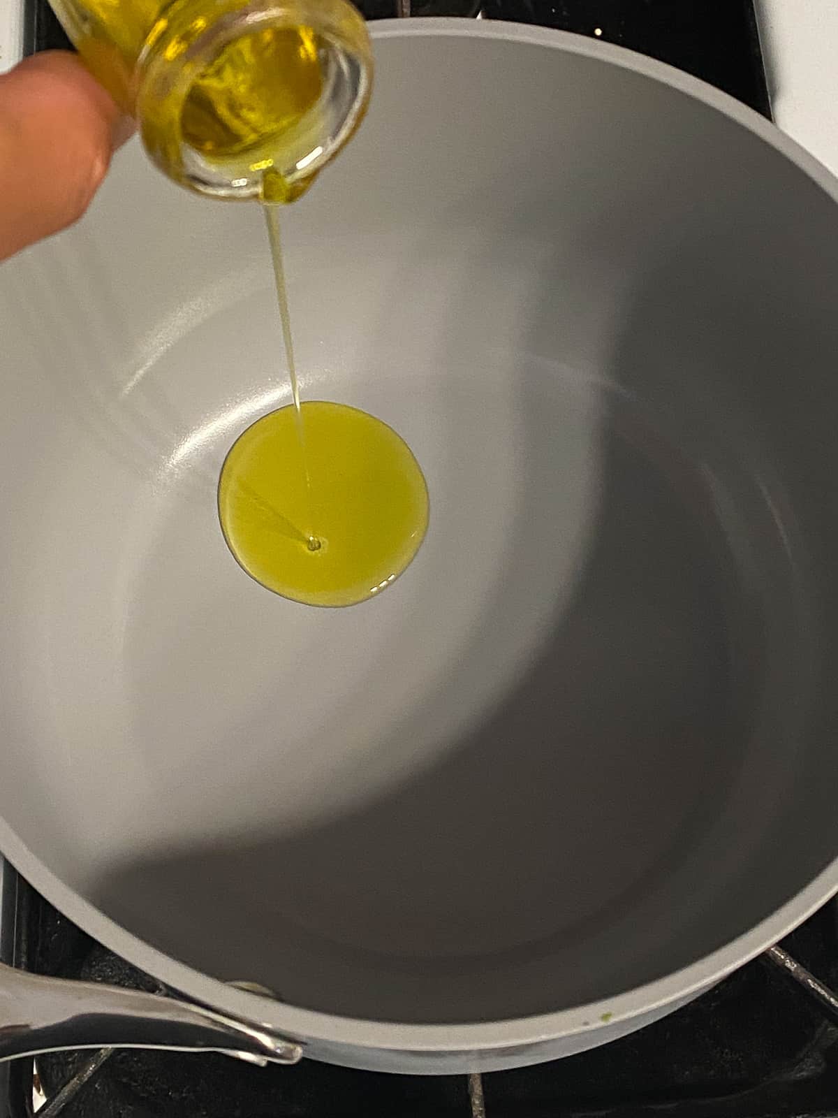 process shot of adding oil to pan