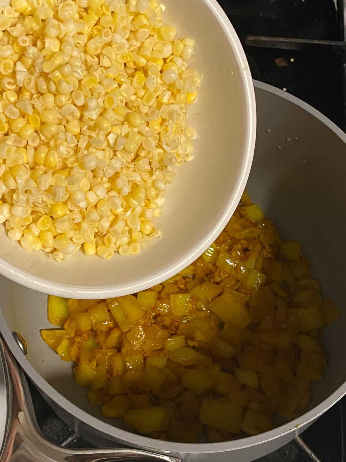 process of adding corn to pan
