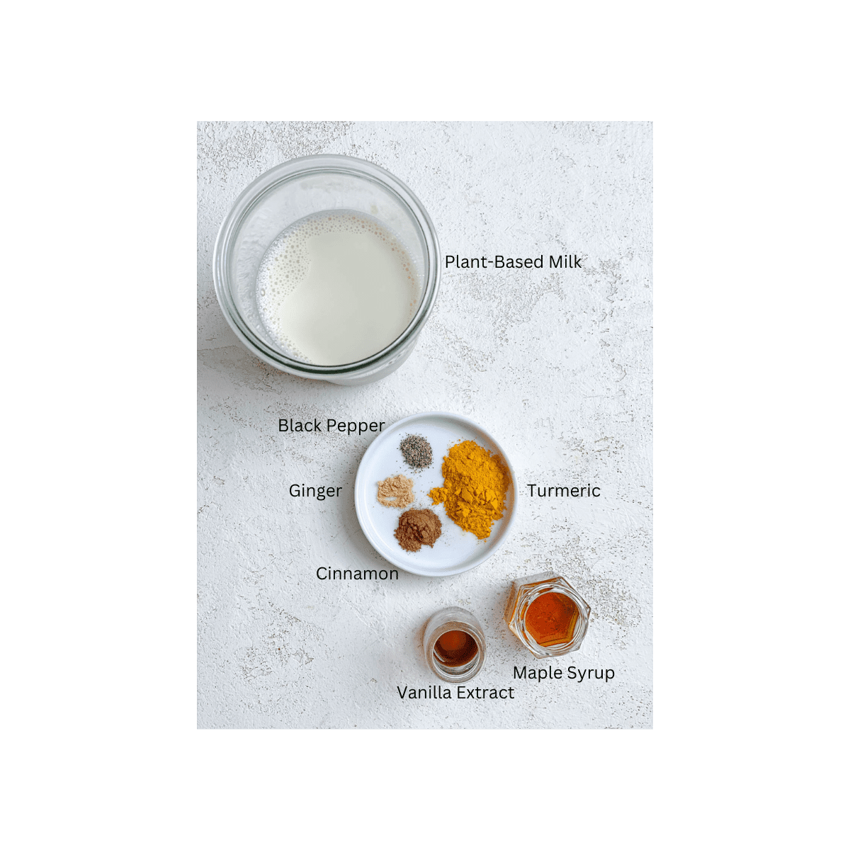 ingredients for Golden Milk measured out against a white surface