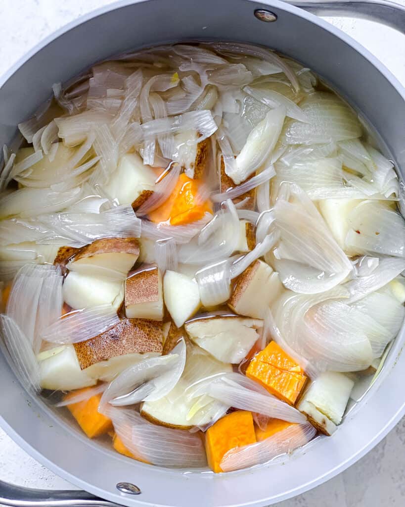 process shot of veggies cooking in a pot