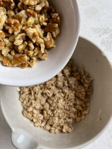 process of adding mixed nuts to peach crumb pie mixture