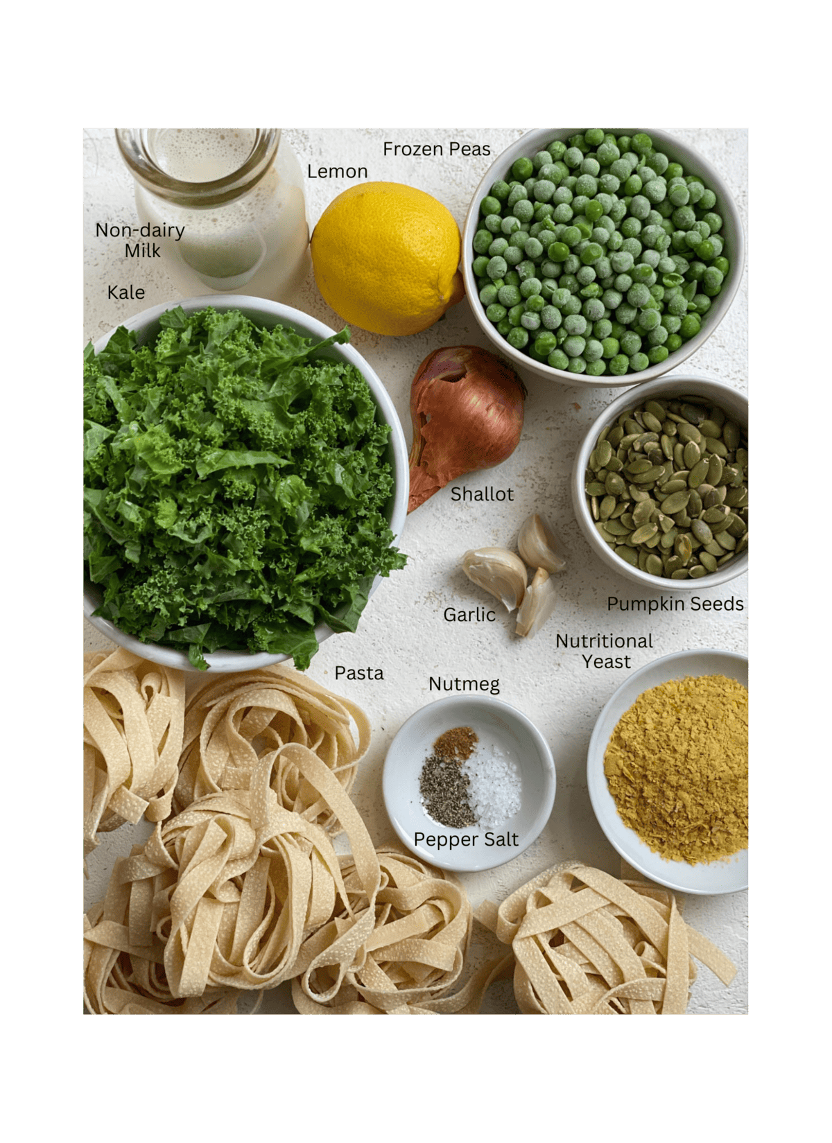ingredients for Dairy Free Alfredo Sauce with Kale and Peas measured out against a white surface