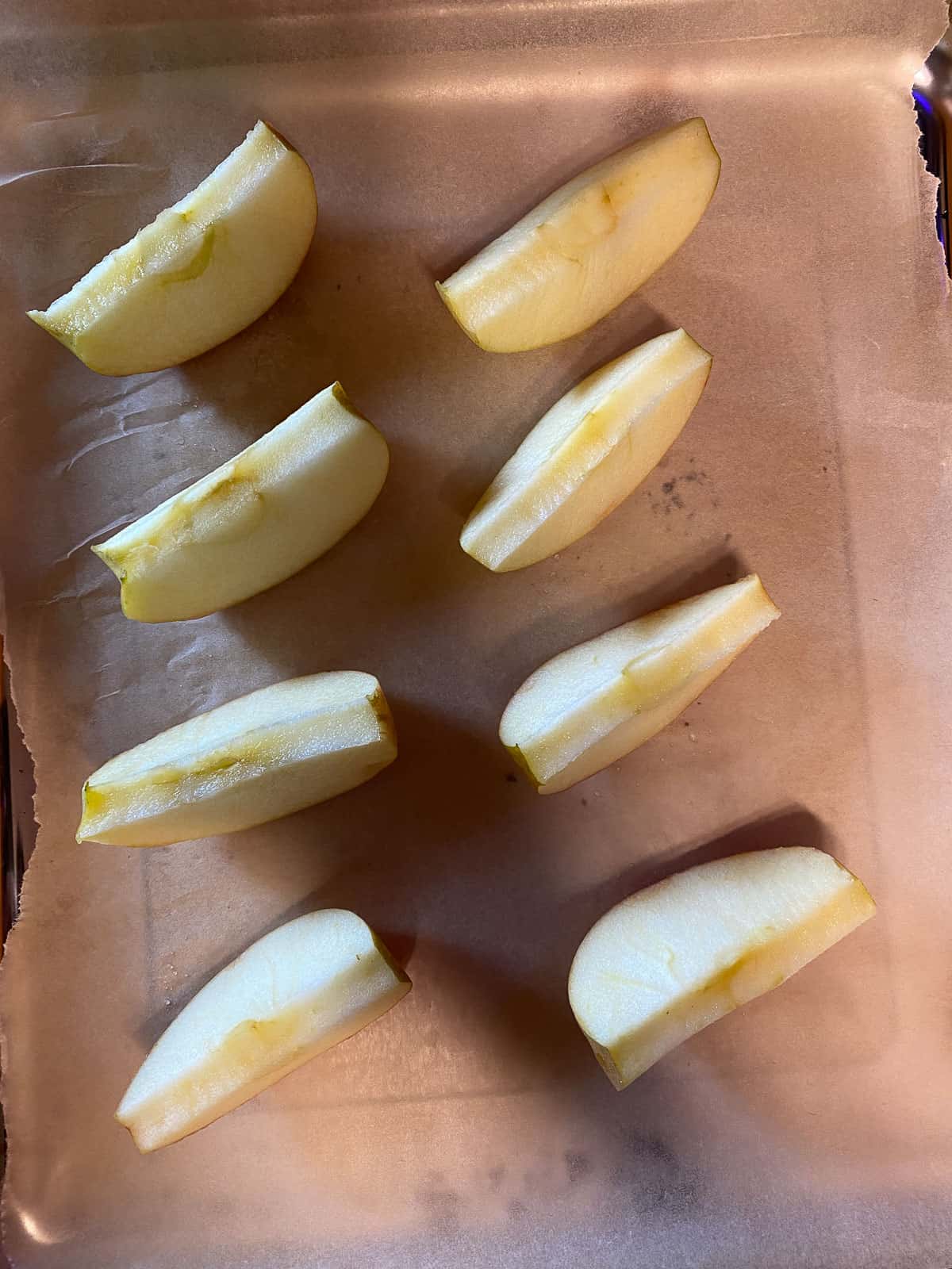 sliced apples on a baking sheet