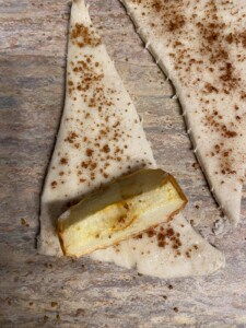 process of rolling apple slice in a crescent roll
