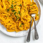 completed Sweet Potato Pasta Sauce with Spaghetti plated against a white surface