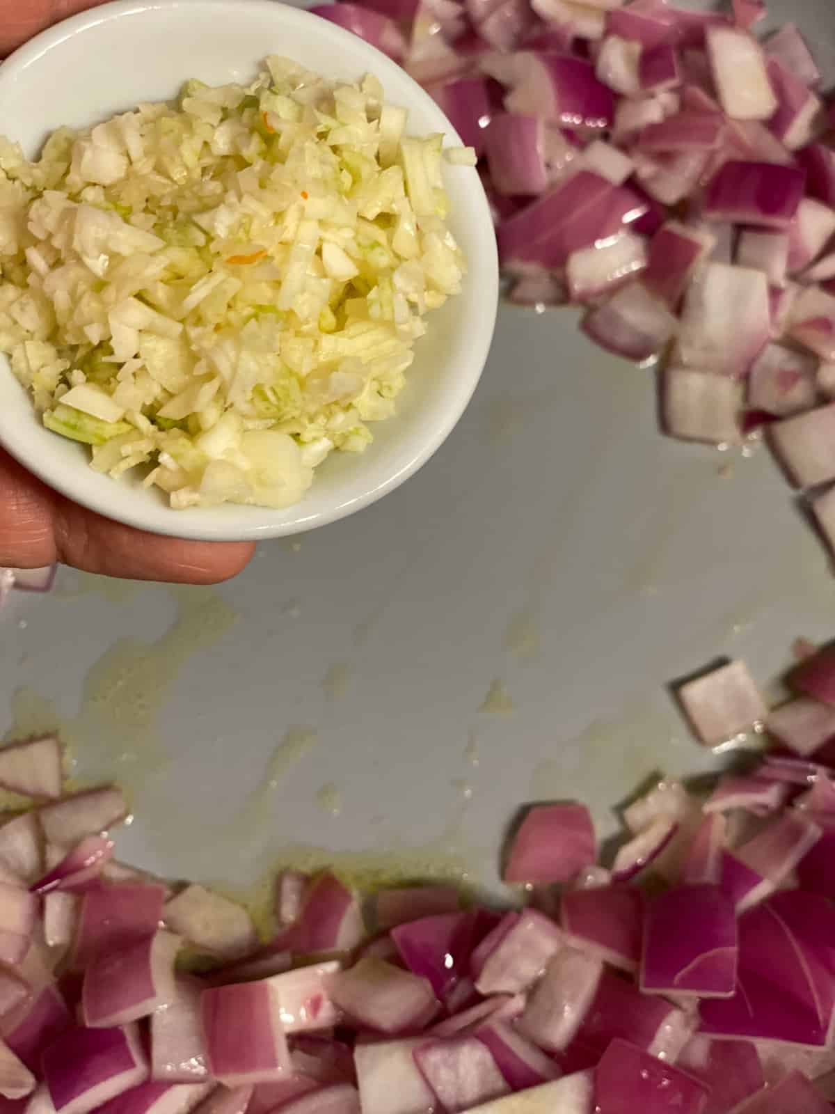 process shot of adding minced garlic to pan
