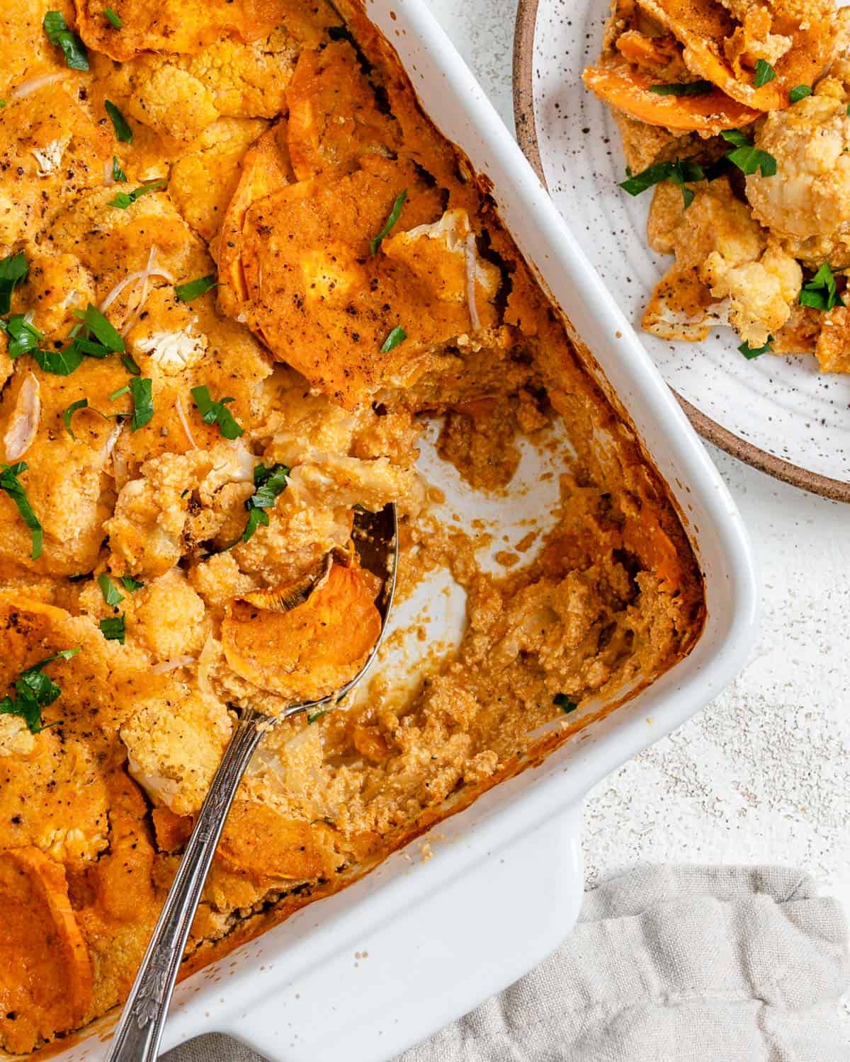 completed Healthy Vegan Cauliflower Casserole in a dish against a which background