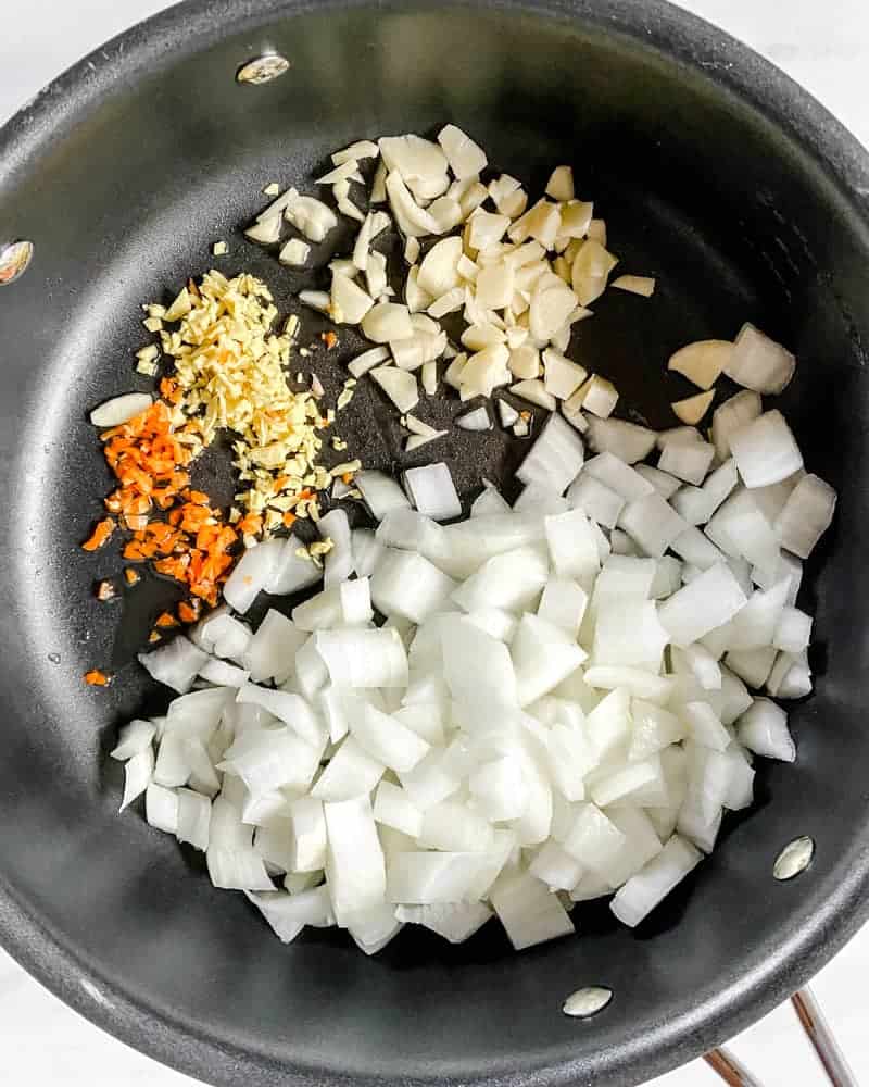 process of brussels sprouts curry being made with ingredients in a pan