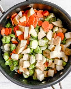process of brussels sprouts curry being made with ingredients in a pan