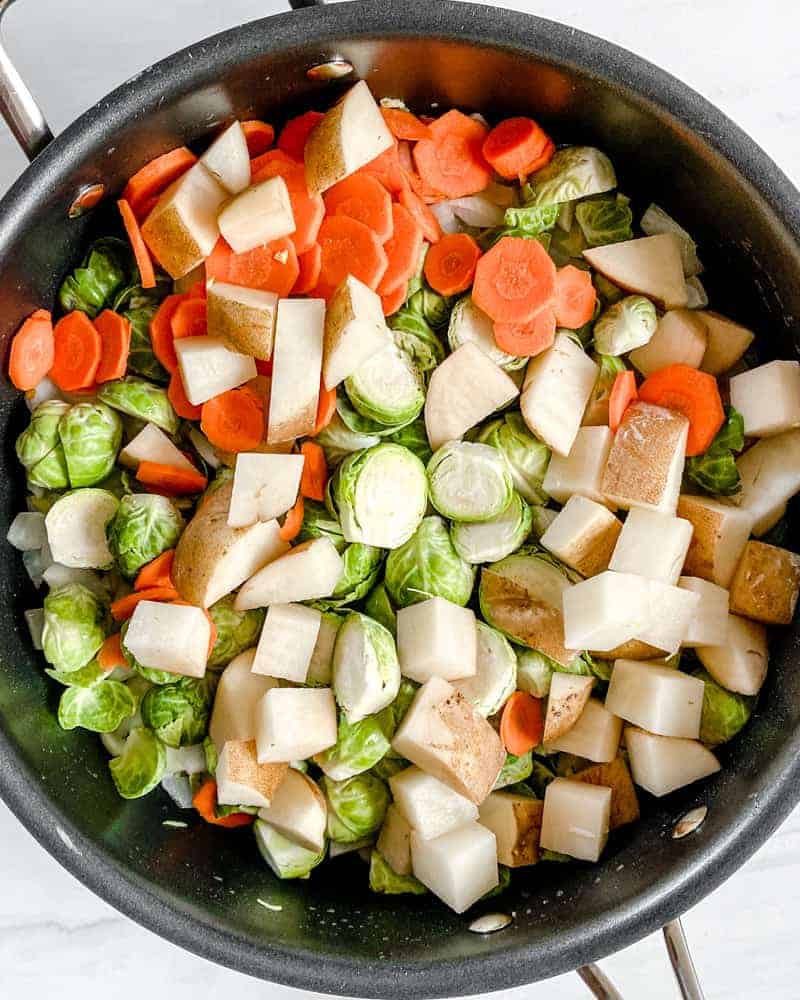 process of brussels sprouts curry being made with ingredients in a pan