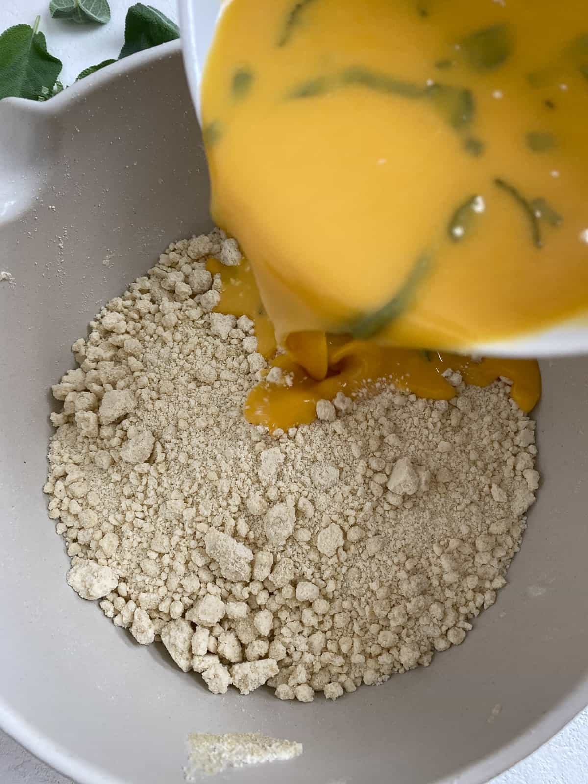 process of pouring butternut squash mixture to bowl of dry ingredients for Butternut Squash Sage Biscuits