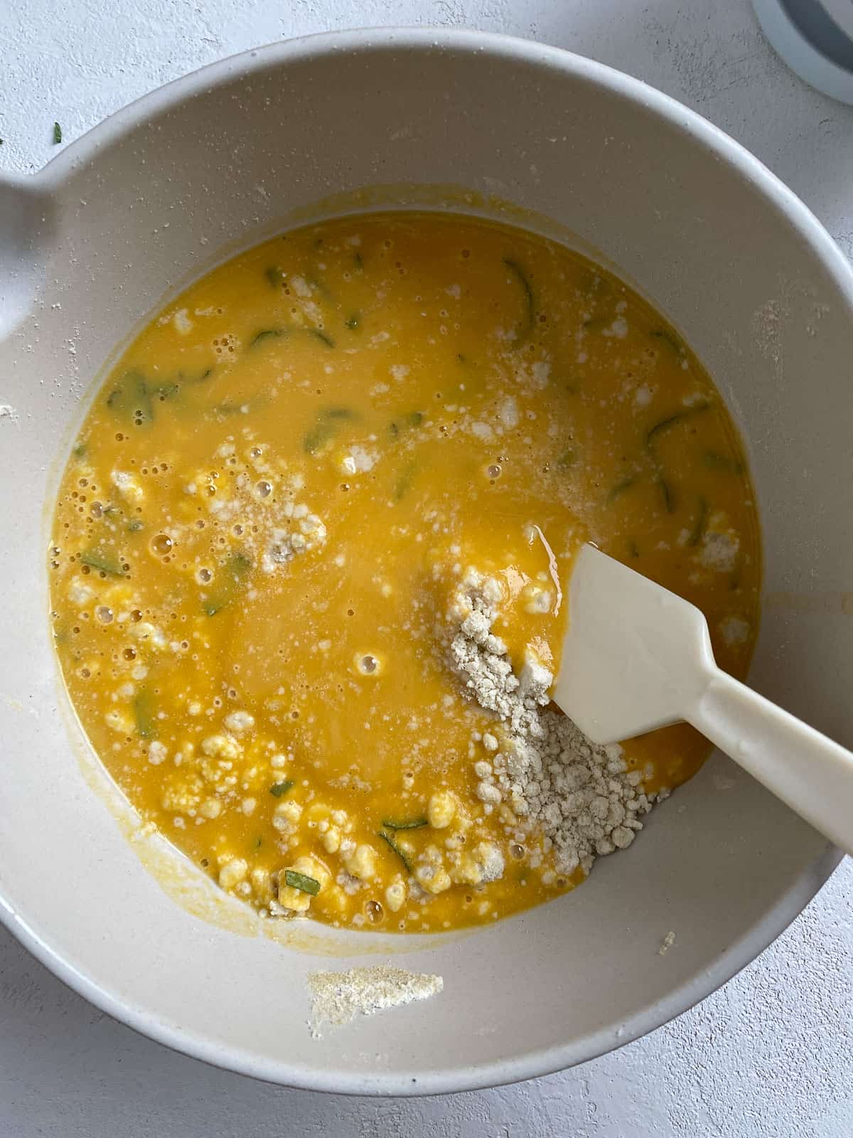 process of mixing ingredients together for Butternut Squash Sage Biscuits in a bowl