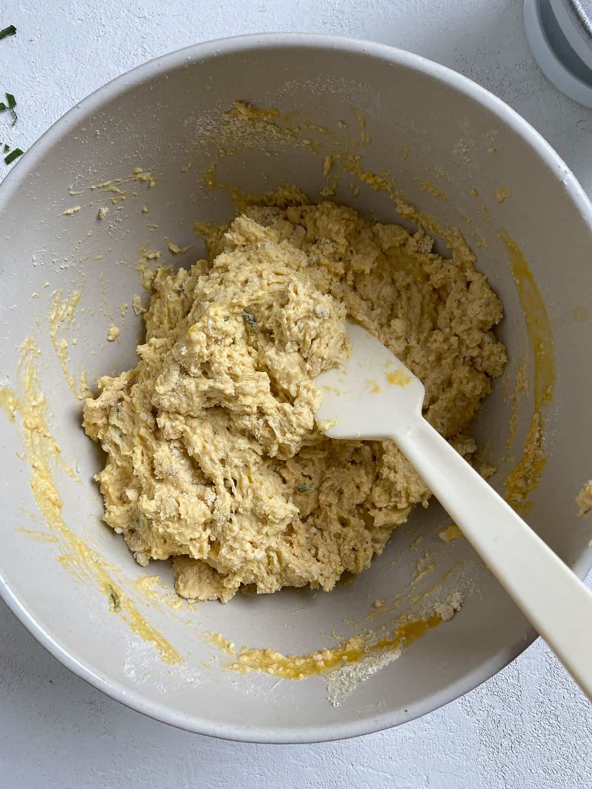 process of mixing ingredients together for Butternut Squash Sage Biscuits in a bowl