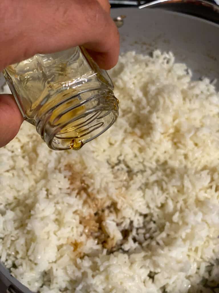 process shot of adding sesame oil to rice
