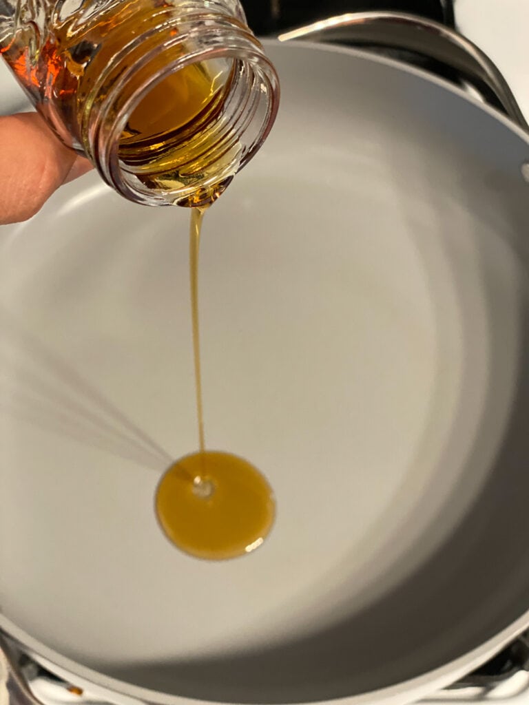 process shot of adding sesame oil to pan