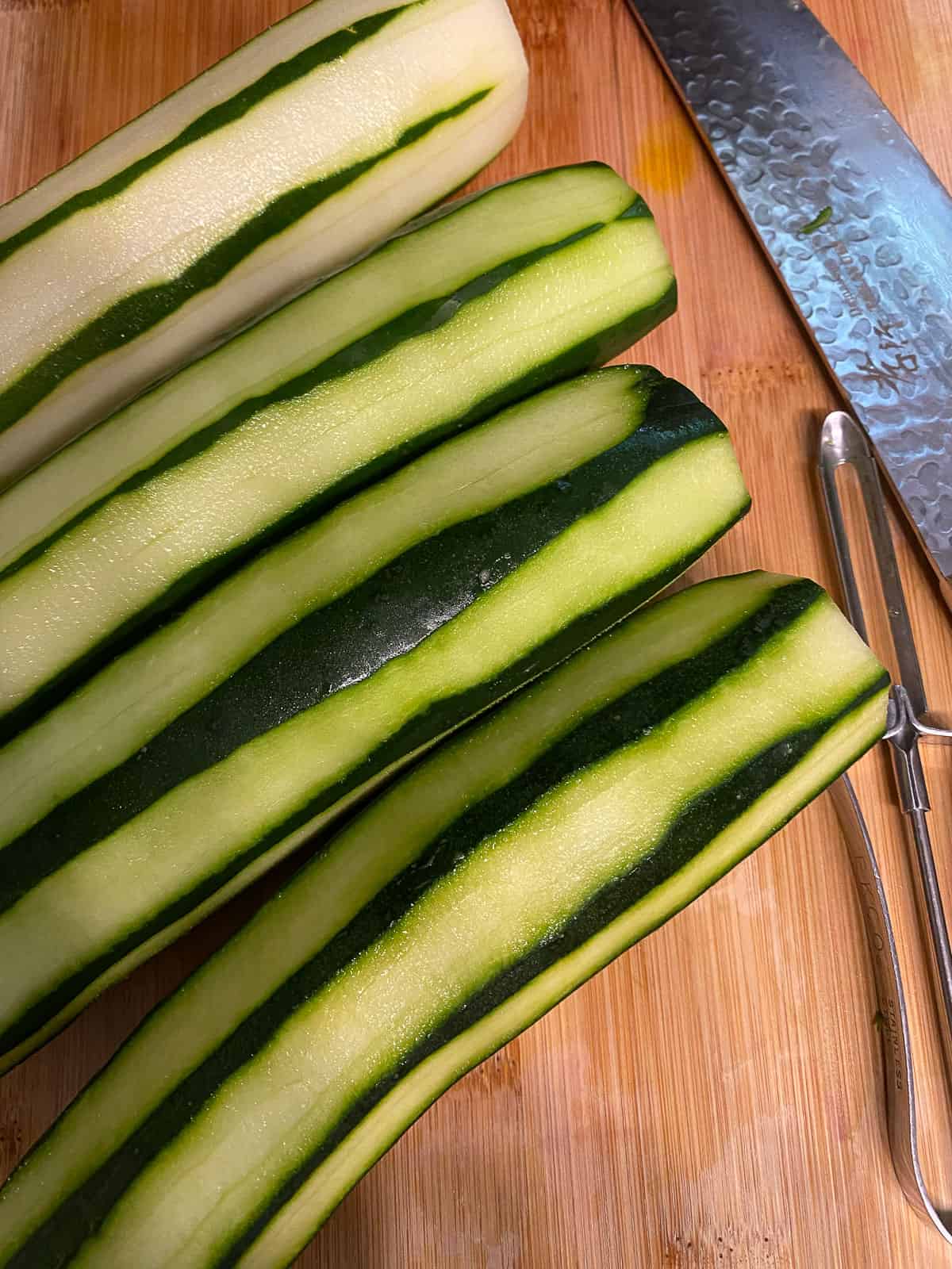 several peeled cucumbers on a cutting board