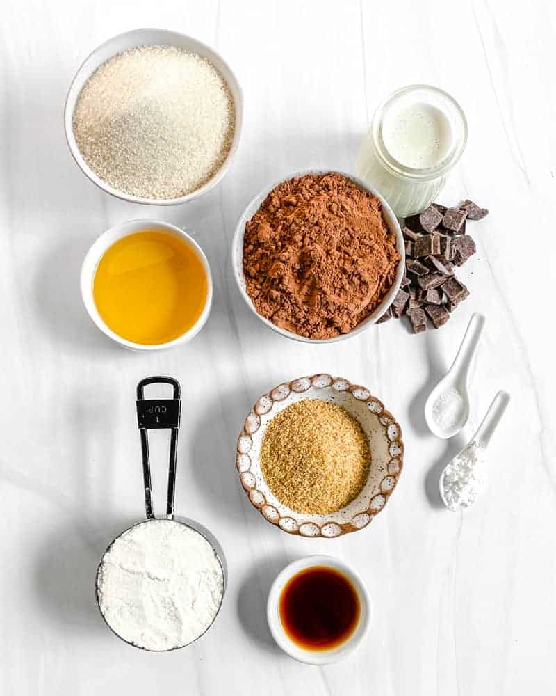 ingredients for Super Fudgy Vegan Brownies measured out on a white surface