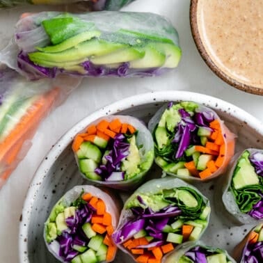 several completed Fresh Rainbow Rolls with Almond Shallot Sauce in a bowl