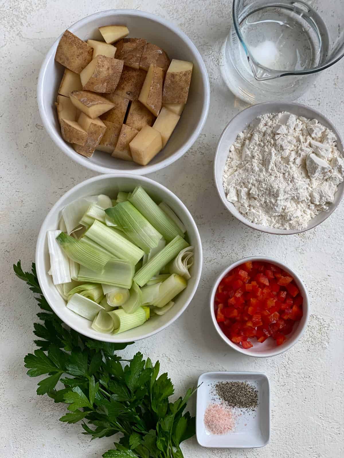 ingredients for Vegan Potato Pancakes measured out against a white background