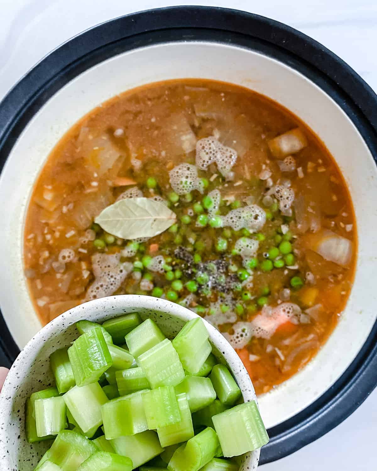 process of making Root Vegetable Lentil Stew with vegetables being added in