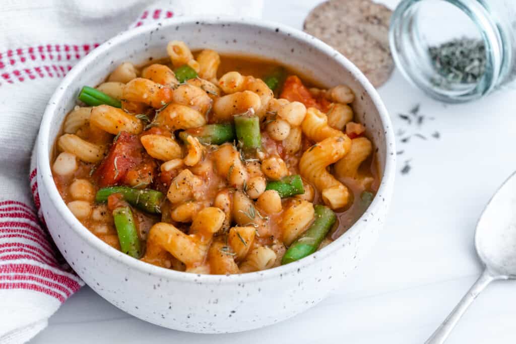 Pasta, Bean & Tomato Soup in a white bowl against a white background