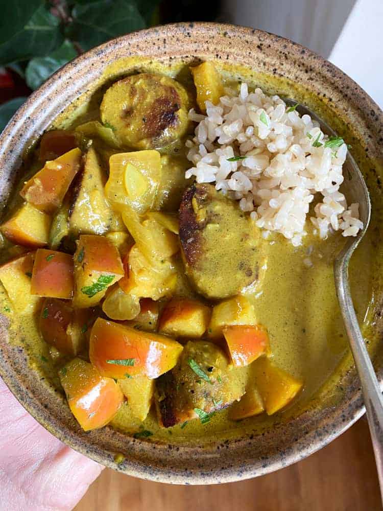 finished Vegan Coconut Curry with Apples in brown bowl 