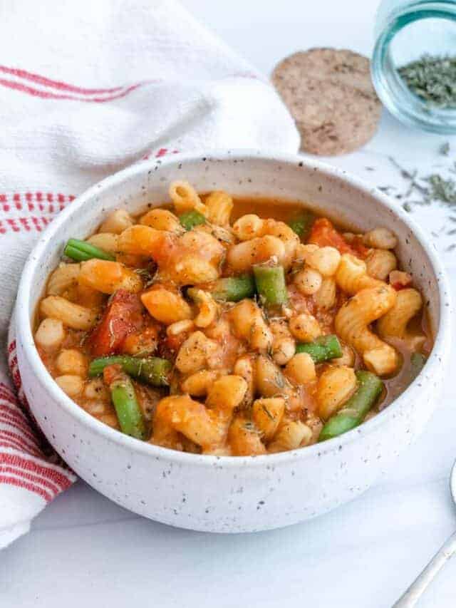 completed Pasta Bean and Tomato Soup in a white bowl against a light surface