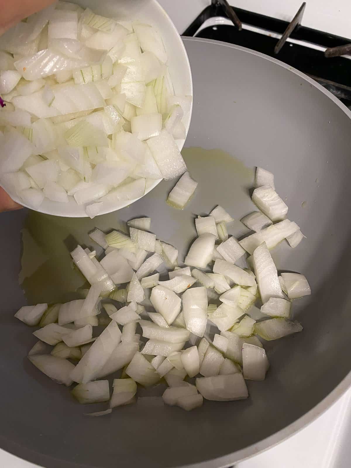process of adding cut onion to pan