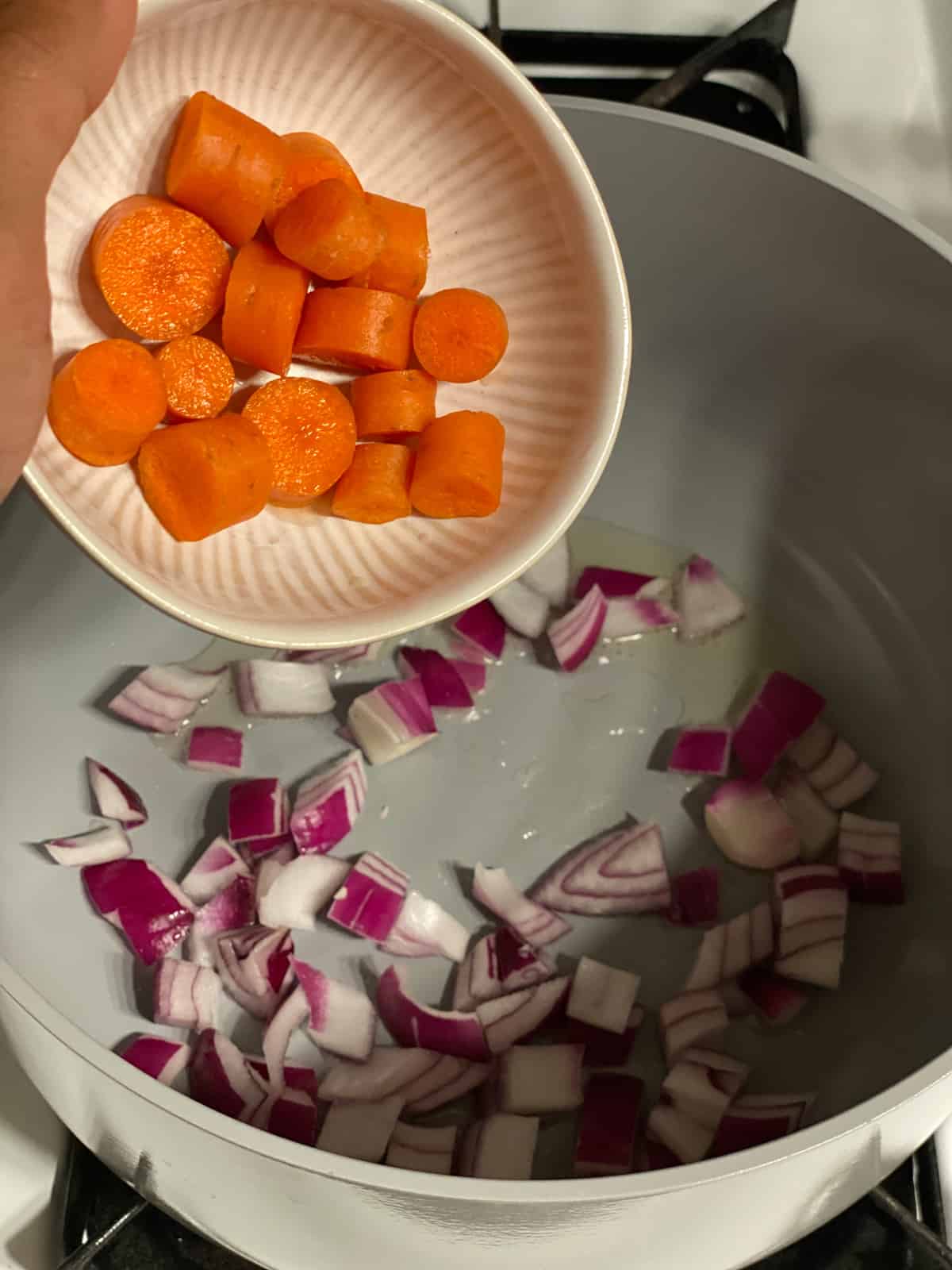 process shot of adding carrots to pan