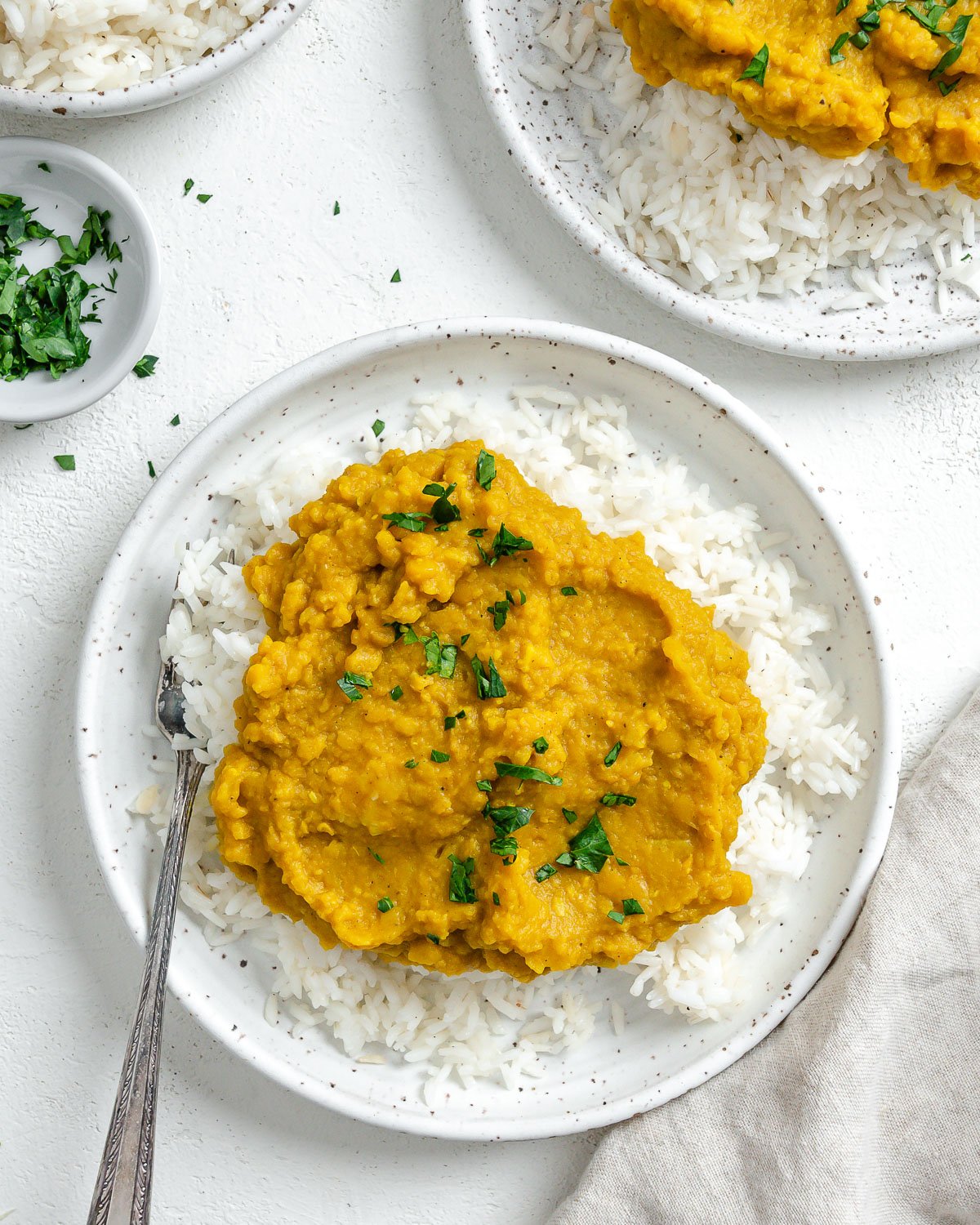 completed Easy Yellow Dal on rice in a white plate against a light background