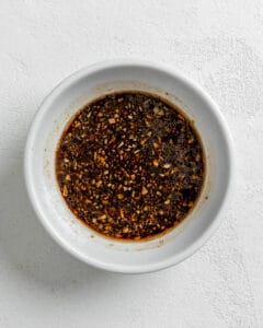 sauce for Sesame Soba Noodles in a white bowl against a white background